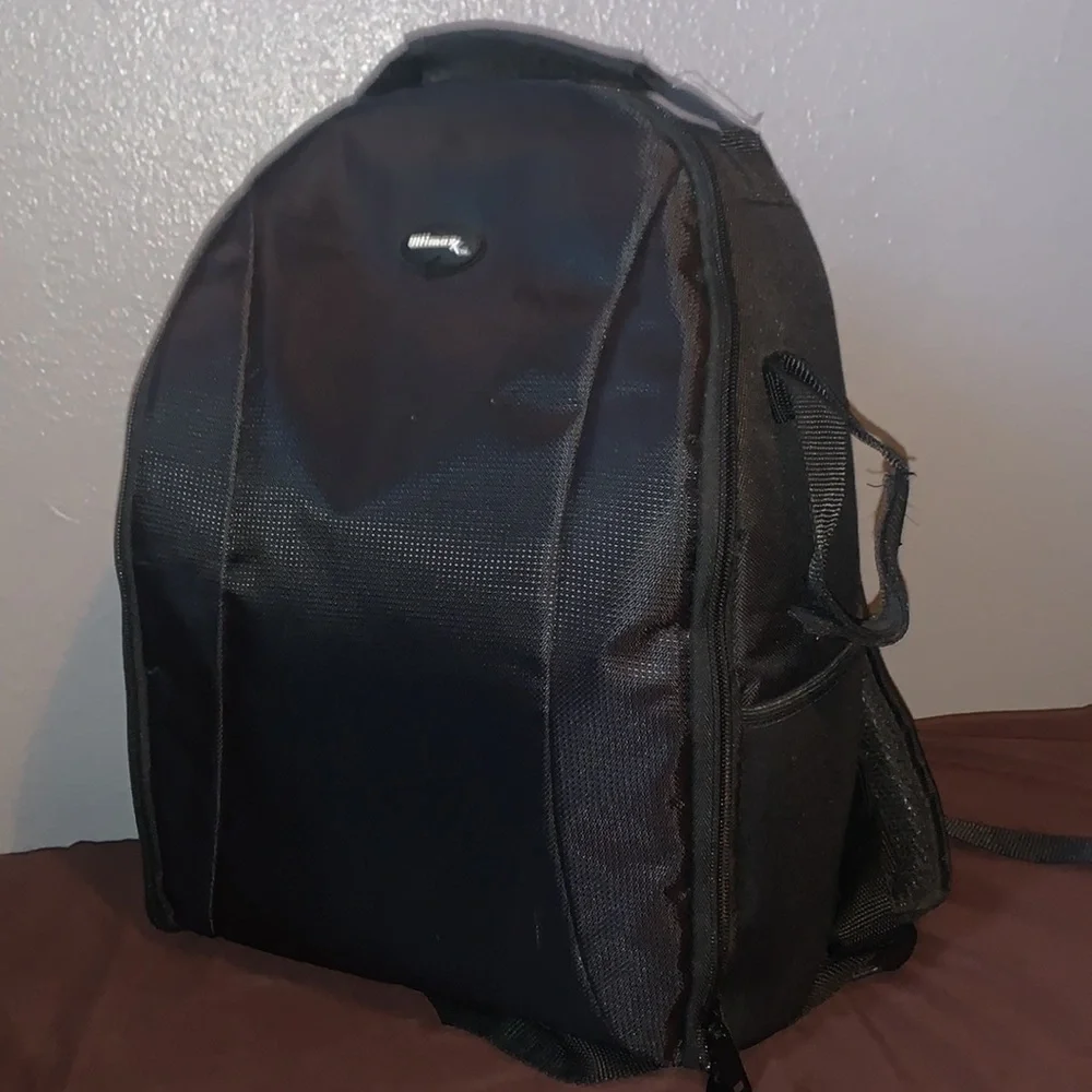 Selling a Canon Rebel T100 Camera with a lot of accessories and a backpack.